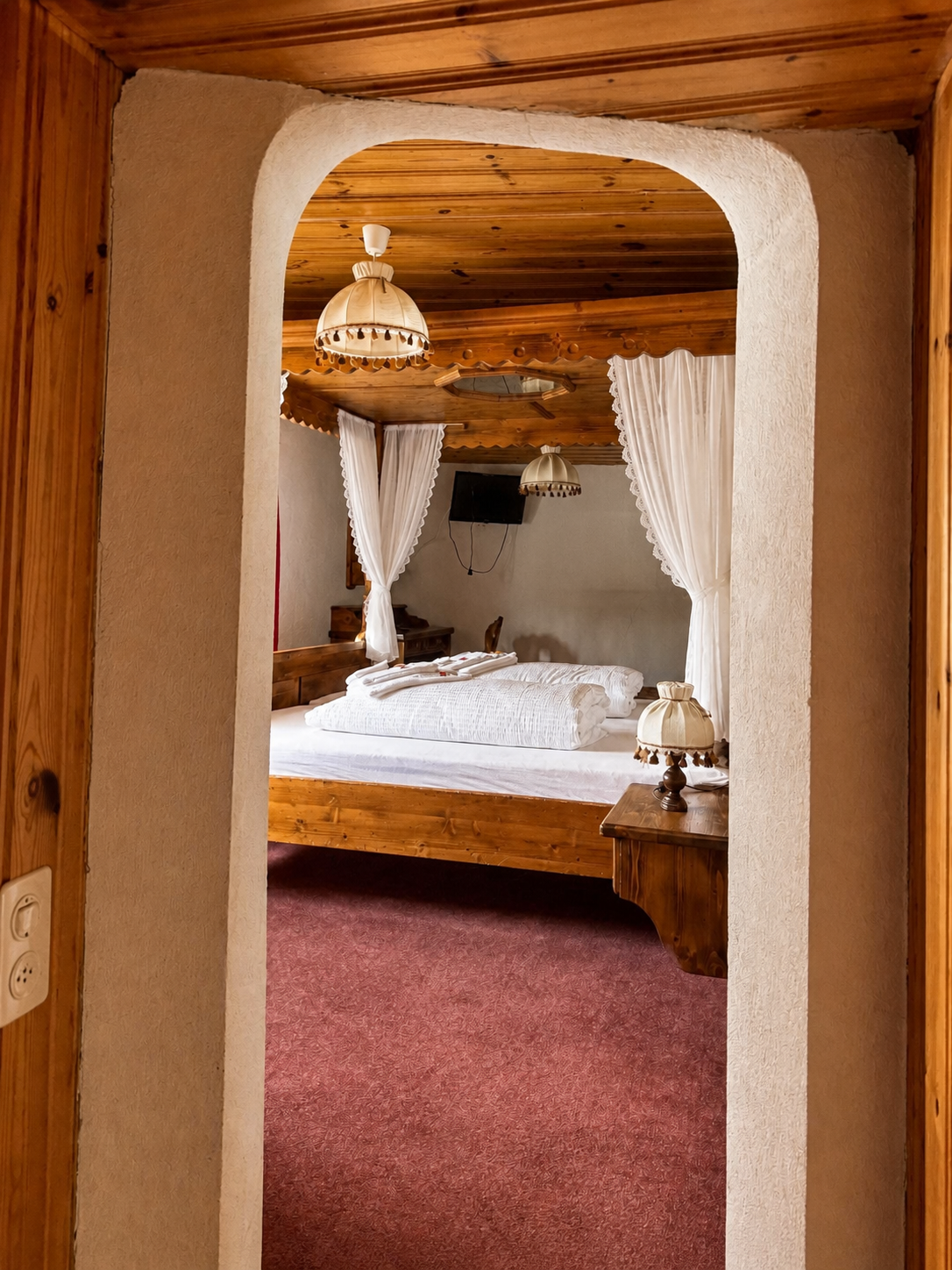 Blick durch den Rundbogen in das traditionelle Alpenzimmer